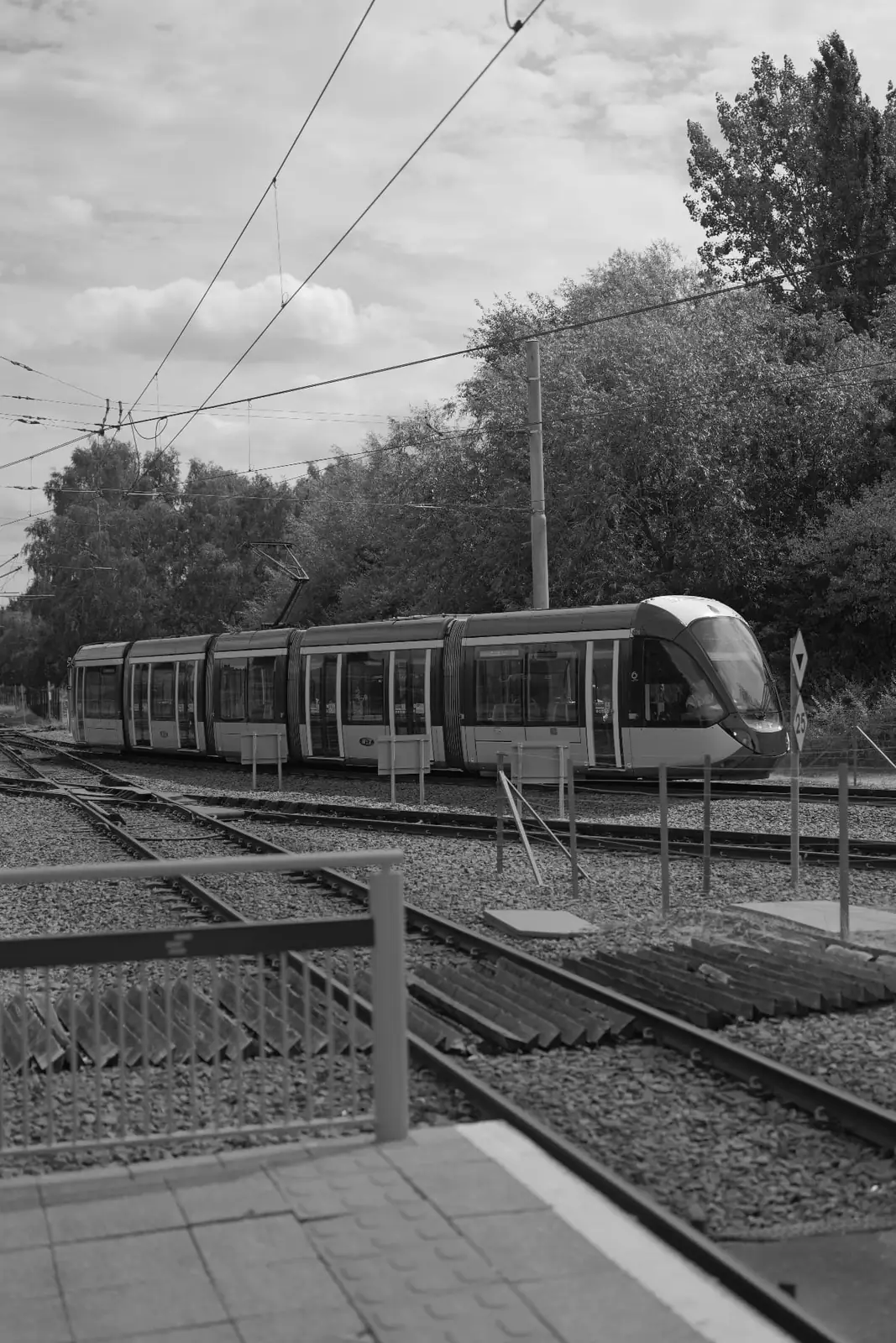 A Nottingham tram passing a level crossing on the city's tramway